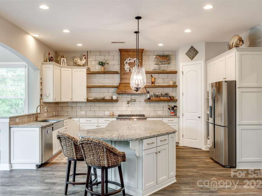 288 Ridge Reserve Drive, Lake Wylie, SC 29710.  MLS# CAR4249323, YatesRealty ID 34210. A chef’s dream—this gourmet kitchen features custom open shelving, designer lighting, a spacious island with bar seating, and high-end appliances ready for your next culinary creation.