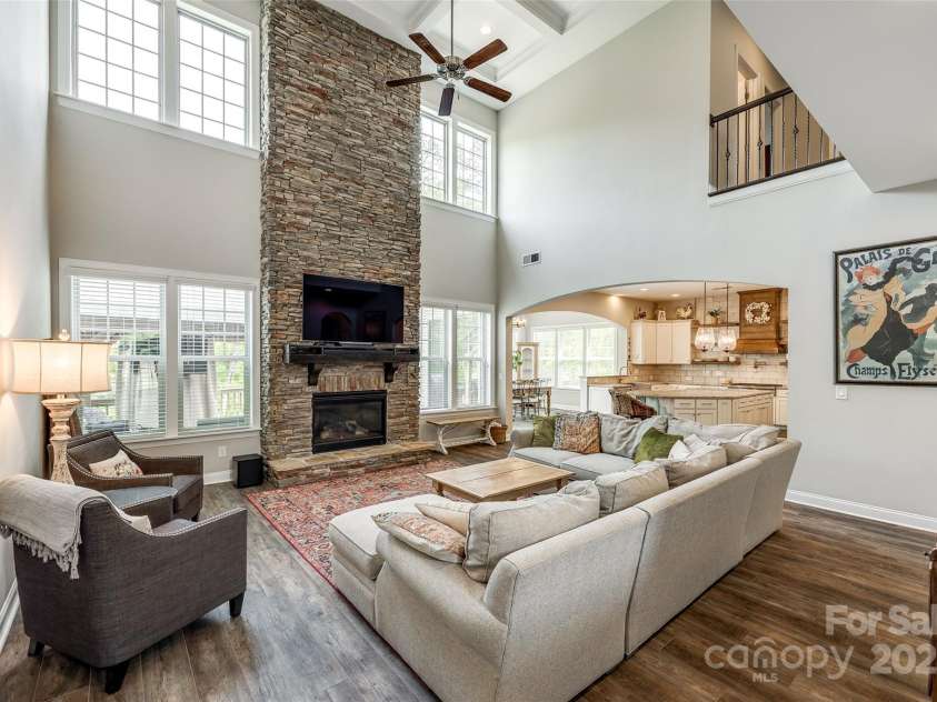 288 Ridge Reserve Drive, Lake Wylie, SC 29710.  MLS# CAR4249323, YatesRealty ID 34210. Soaring ceilings, a stunning stone fireplace, and open-concept living make this great room the heart of the home—perfect for cozy nights or effortless entertaining.