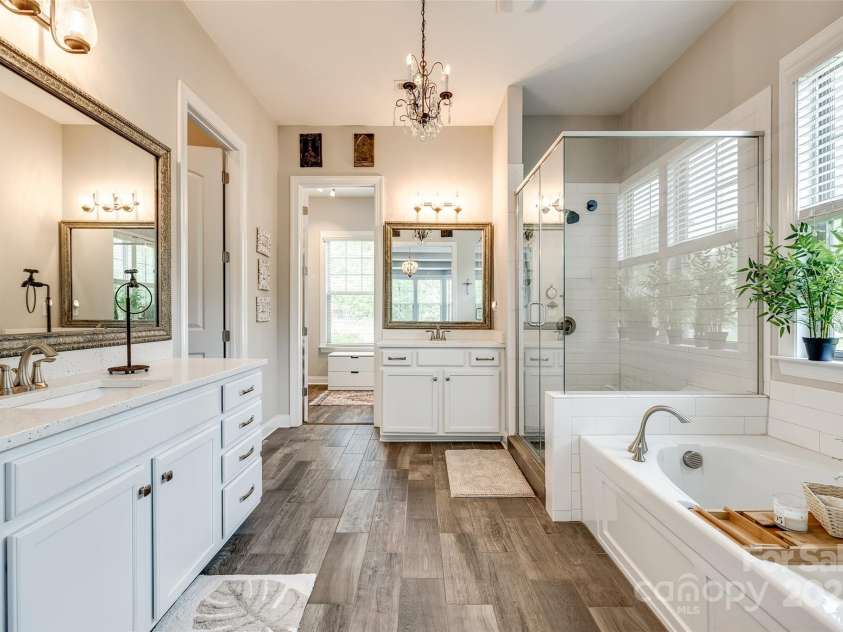 288 Ridge Reserve Drive, Lake Wylie, SC 29710.  MLS# CAR4249323, YatesRealty ID 34210. Start and end your day in luxury—this beautifully appointed bath features dual vanities, a glass-enclosed shower, and a soaking tub bathed in natural light.