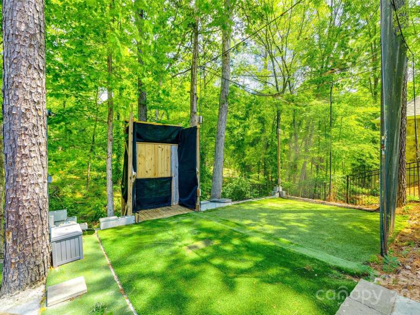 288 Ridge Reserve Drive, Lake Wylie, SC 29710.  MLS# CAR4249323, YatesRealty ID 34210. Unique and versatile—this dedicated sports zone is ideal for golf swing practice, axe throwing, or simply having fun outdoors.