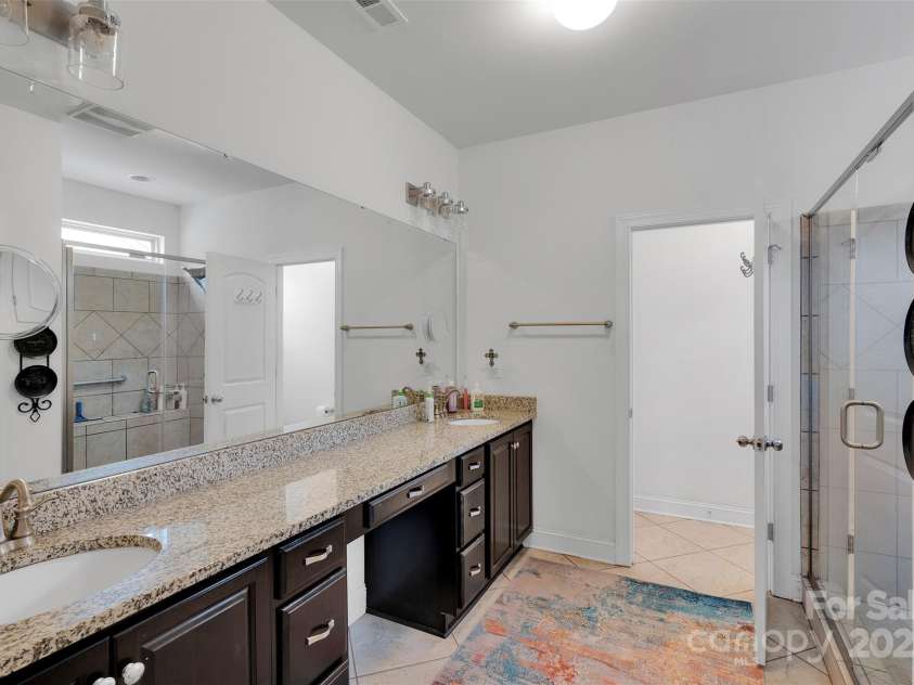 5105 Forest Knoll Court, Indian Trail, NC 28079.  MLS# CAR4282019, YatesRealty ID 34237. Dual sinks and dressing area. Plenty of storage with drawers and cabinets. Large linen closet adds more storage to this beautiful bathroom