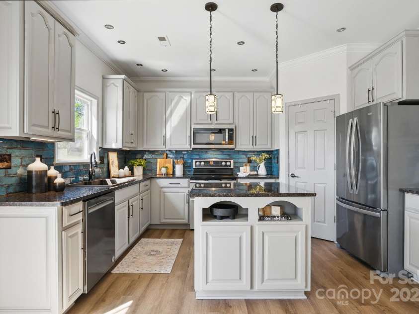 7635 Carrington Forest Lane, Matthews, NC 28105.  MLS# CAR4239500, YatesRealty ID 3424. Large Kitchen with Tall Cabinets, upgraded fixtures, Central Island, and Designer Cabinets