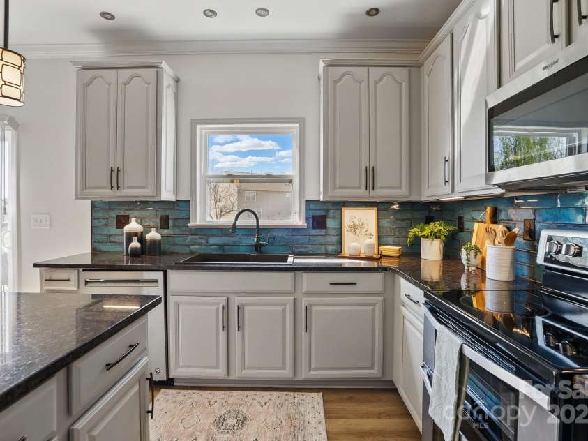 7635 Carrington Forest Lane, Matthews, NC 28105.  MLS# CAR4239500, YatesRealty ID 3424. Large Kitchen with Tall Cabinets, upgraded fixtures, Central Island, and Designer Cabinets