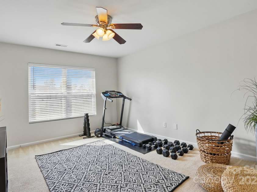 7635 Carrington Forest Lane, Matthews, NC 28105.  MLS# CAR4239500, YatesRealty ID 3424. Secondary Bedroom 1, Currently Being used as Fitness Room. Generous Closet Size.