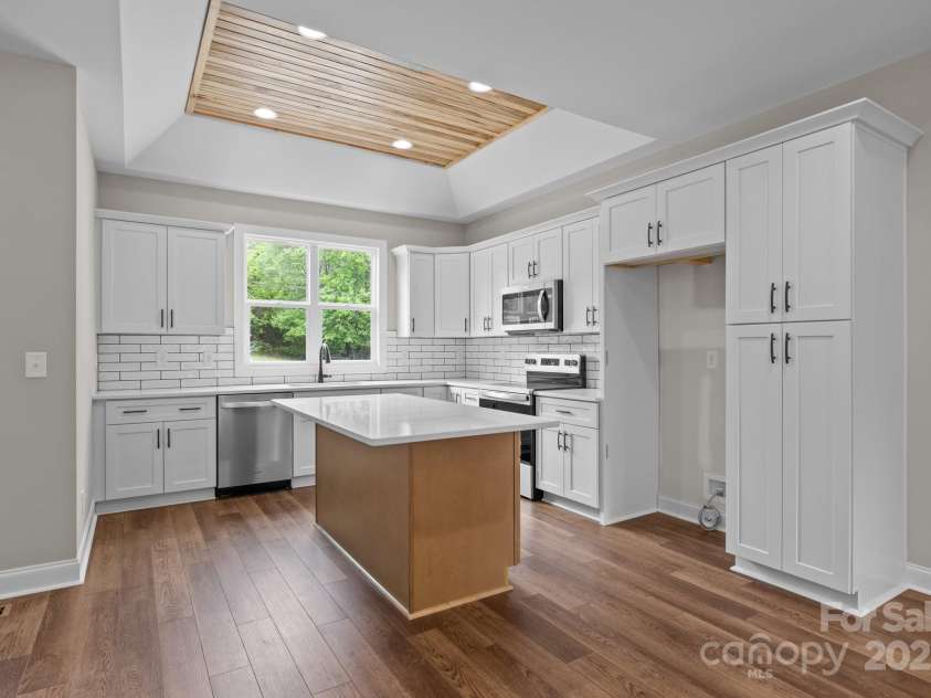5037 Faith Road, Salisbury, NC 28146.  MLS# CAR4204735, YatesRealty ID 34251. Kitchen with wormy maple wood inset in a trey ceiling