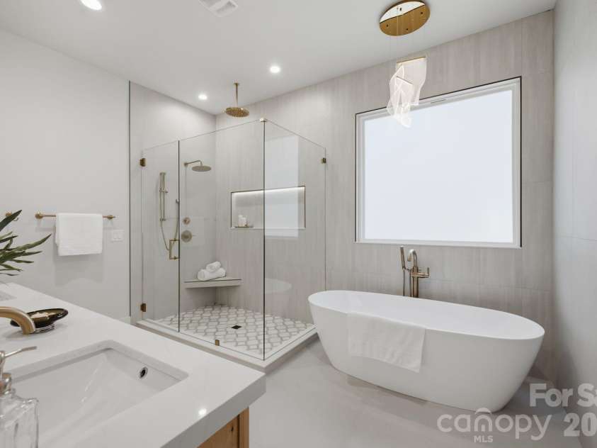 3119 Shenandoah Avenue, Charlotte, NC 28205.  MLS# CAR4394625, YatesRealty ID 34254. Spa inspired bathroom with soaking tub, porcelain tile, illuminated shower niche, marble shower flooring, Triple Champagne bronze shower heads.