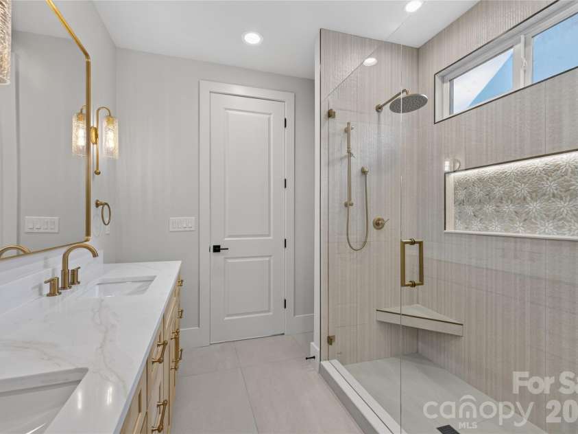 3119 Shenandoah Avenue, Charlotte, NC 28205.  MLS# CAR4394625, YatesRealty ID 34254. You guested it...illuminated shower niche! Not pictured linen closet. Look at those scones! Dual sink vanities, Calcutta quartz, champagne bronze lighting and fixtures, porcelain tile flooring, rainwater & hand held