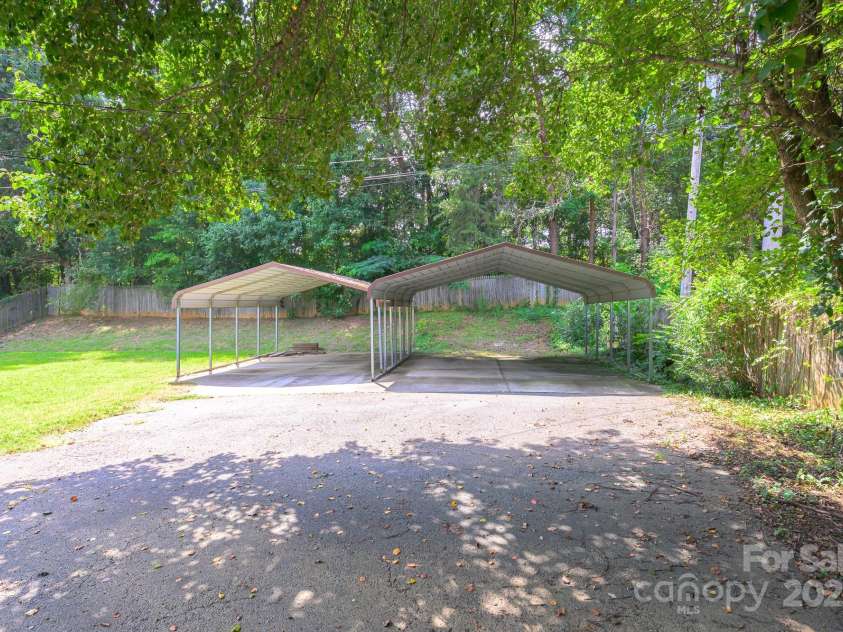 9012 McMillian Drive, Harrisburg, NC 28075.  MLS# CAR4295135, YatesRealty ID 34264. Driveway and carports