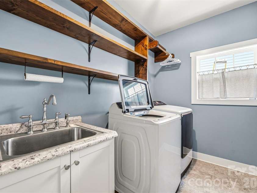 16 Henbit Way, Arden, NC 28704.  MLS# CAR4394506, YatesRealty ID 34286. Laundry Room with spacious storage, shelves, and a full sink.