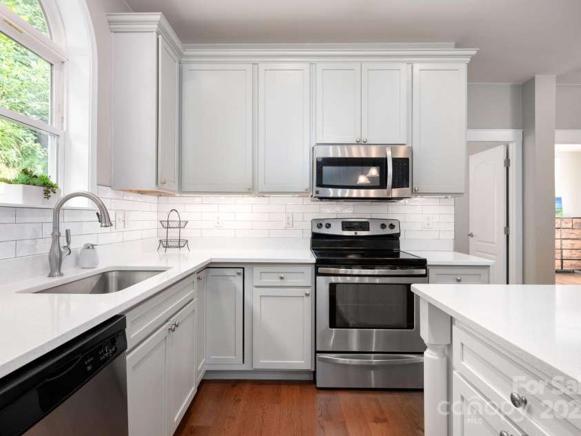 209 Patriots Drive, Asheville, NC 28805.  MLS# CAR4291919, YatesRealty ID 34321. Grey cabinets, plenty of storage.