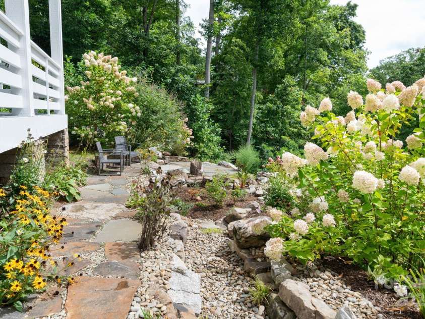 209 Patriots Drive, Asheville, NC 28805.  MLS# CAR4291919, YatesRealty ID 34321. Rocks and mulch and flowers.