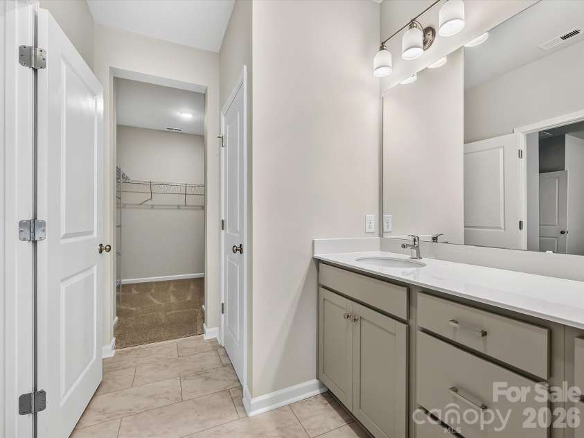 6557 Fire Lily Lane, Charlotte, NC 28216.  MLS# CAR4383907, YatesRealty ID 34325. Owners Bath leading into the Oversized Owner's Closet