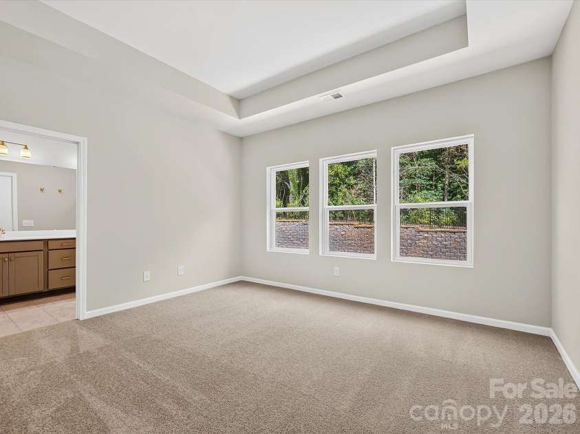 6557 Fire Lily Lane, Charlotte, NC 28216.  MLS# CAR4383907, YatesRealty ID 34325. Spacious Owners Suite Offering an Elevated Tray Ceiling and Natural Light