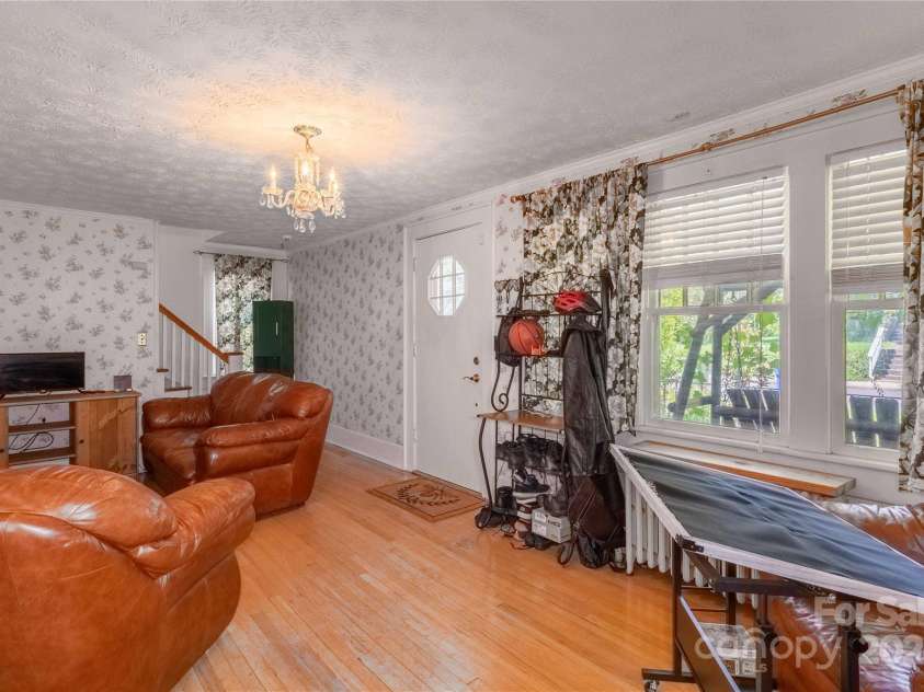 56 Brevard Road, Asheville, NC 28806.  MLS# CAR4293196, YatesRealty ID 34333. Living room stairs in the background