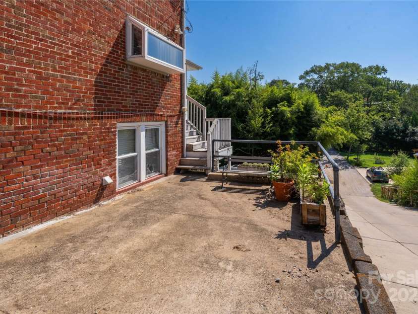 56 Brevard Road, Asheville, NC 28806.  MLS# CAR4293196, YatesRealty ID 34333. Parking spot next to the house