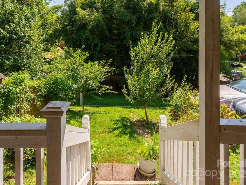 56 Brevard Road, Asheville, NC 28806.  MLS# CAR4293196, YatesRealty ID 34333. Stairs from bottom back deck to backyard