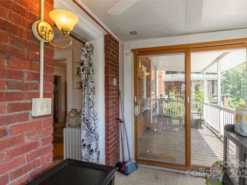 56 Brevard Road, Asheville, NC 28806.  MLS# CAR4293196, YatesRealty ID 34333. Sunroom off kitchen