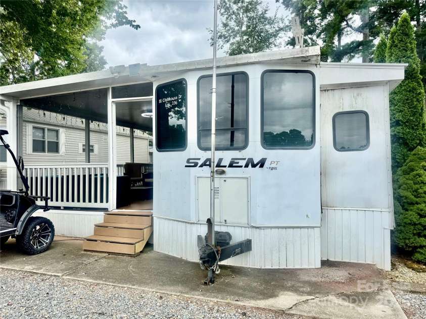 111 Club House Extension, New London, NC 28127.  MLS# CAR4295285, YatesRealty ID 34337. Street side view of Camper Home