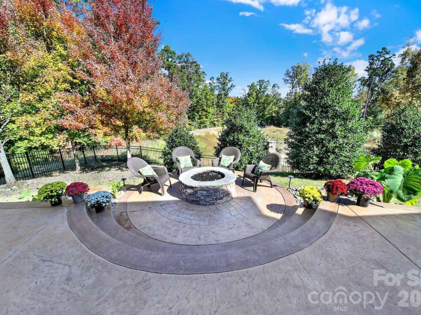 989 Emory Lane, Fort Mill, SC 29708.  MLS# CAR4356402, YatesRealty ID 34337. 2 water feature rocks on each side of gas fire pit