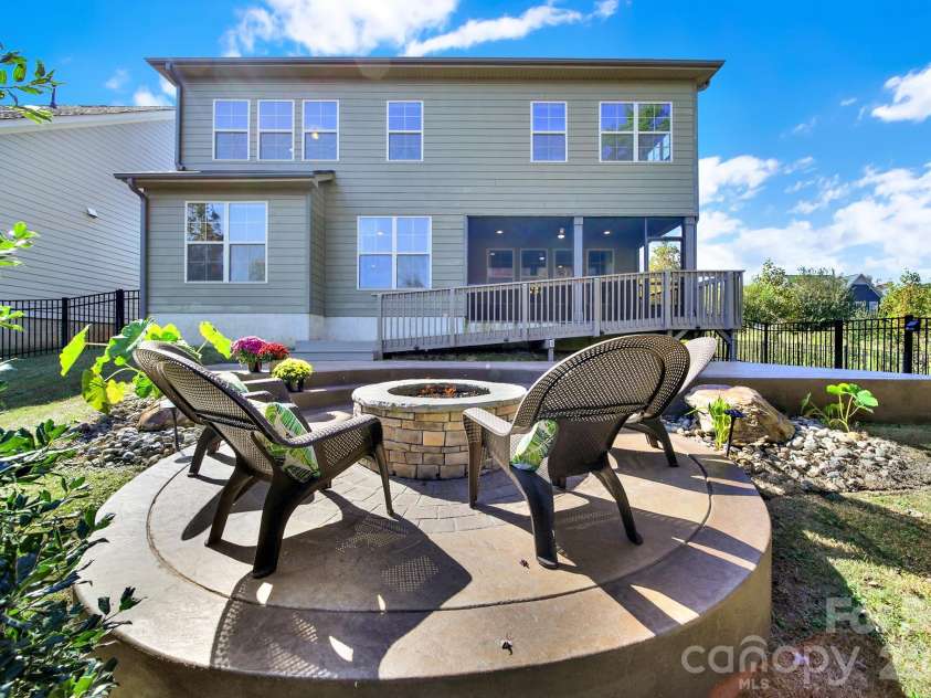 989 Emory Lane, Fort Mill, SC 29708.  MLS# CAR4356402, YatesRealty ID 34337. 2 water feature rocks on each side of gas fire pit