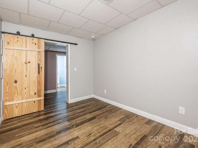 46 Badger Run, Hendersonville, NC 28739.  MLS# CAR4281037, YatesRealty ID 34340. Bedroom/bonus room with barn door and window on lower level