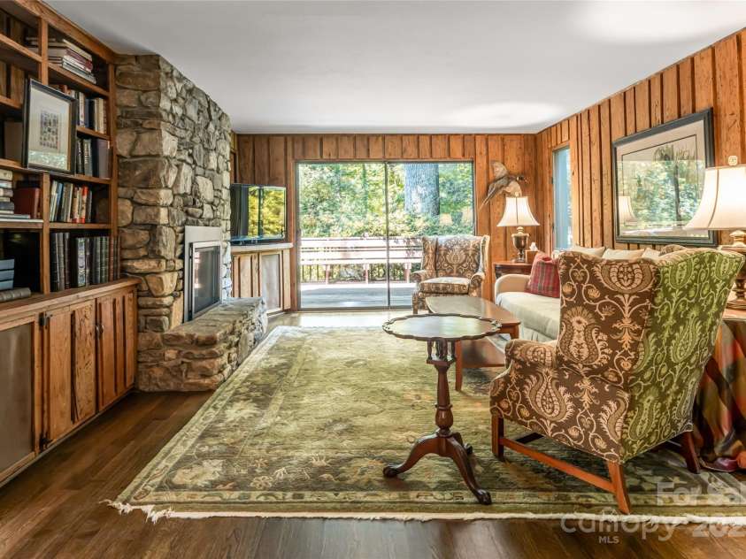 33 Deerhaven Lane, Asheville, NC 28803.  MLS# CAR4276506, YatesRealty ID 34343. Spacious den wrapped in wormy chestnut for a cozy living space