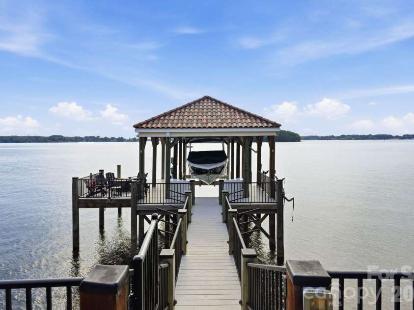 16920 Harbor Master Cove, Cornelius, NC 28031.  MLS# CAR4394741, YatesRealty ID 34351. Covered dock with a tile roof, boatlift, & seating area. 