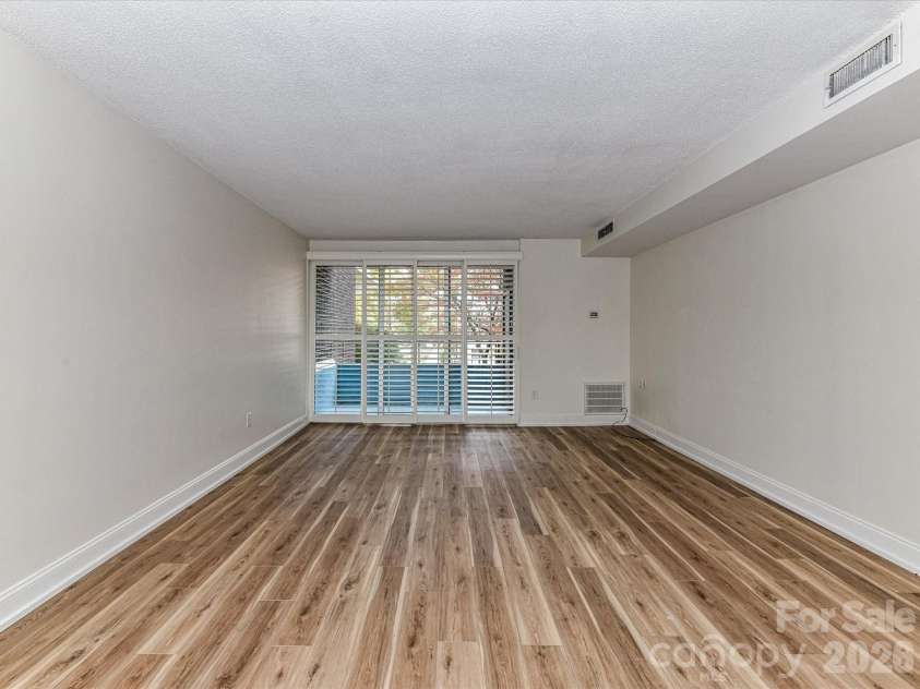 1300 Reece Road, Charlotte, NC 28209.  MLS# CAR4318620, YatesRealty ID 3436. Family Room w/sliding glass doors to Balcony