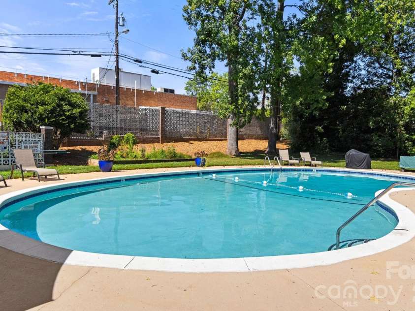 1300 Reece Road, Charlotte, NC 28209.  MLS# CAR4414970, YatesRealty ID 3436. Pool is inside brick fence with mature landscaping
