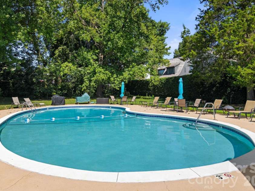 1300 Reece Road, Charlotte, NC 28209.  MLS# CAR4414970, YatesRealty ID 3436. Pool is surrounded with mature landscaping and brick fence