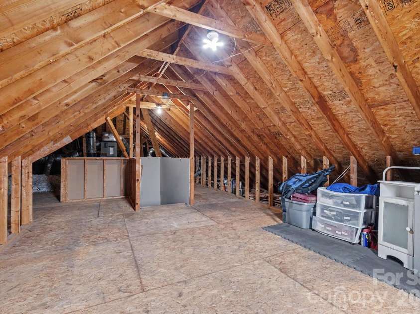 115 Blakemore Drive, Shelby, NC 28152.  MLS# CAR4393685, YatesRealty ID 34369. There are fixed stairs leading to this unfinished area above the garage...