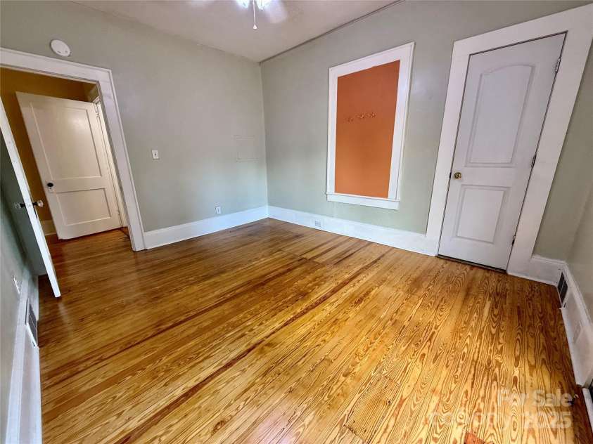 122 Beaver Street, Forest City, NC 28043.  MLS# CAR4294326, YatesRealty ID 34376. Bedroom with warm hardwoods