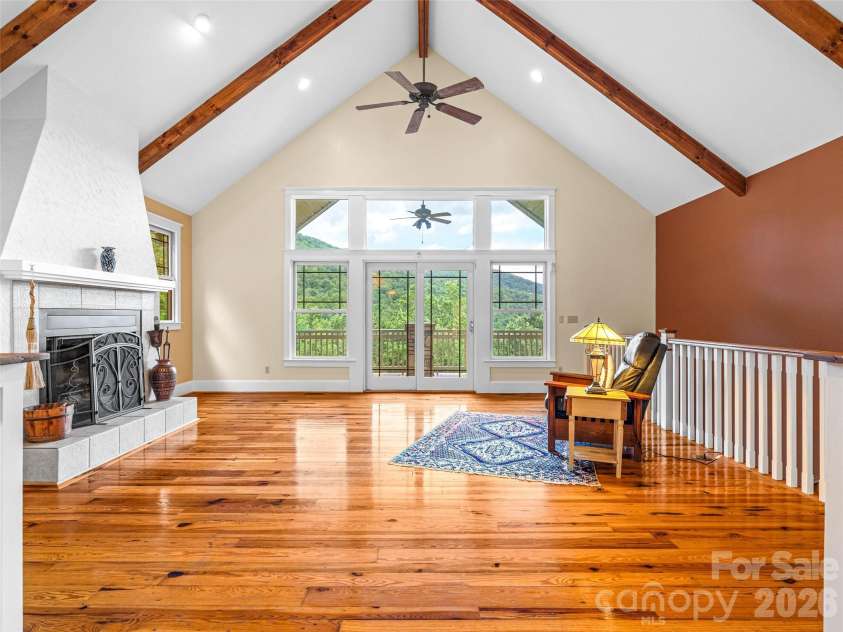 890 Stoney Stream Lane, Arden, NC 28704.  MLS# CAR4395817, YatesRealty ID 34385. Great room with soaring ceilings, wood beams, and direct access to the covered deck. 