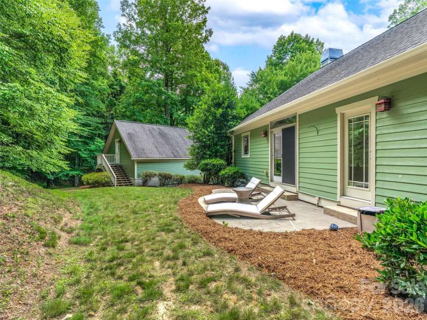 890 Stoney Stream Lane, Arden, NC 28704.  MLS# CAR4395817, YatesRealty ID 34385. Quiet and private back patio, with stairs to studio room over garage in the background.