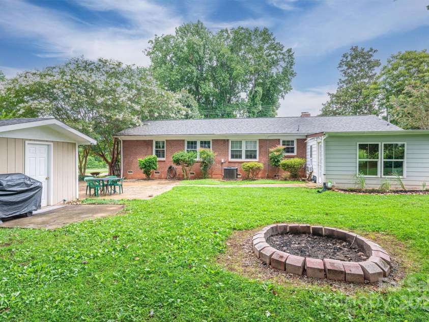 515 Lakewood Drive, Gastonia, NC 28056.  MLS# CAR4295444, YatesRealty ID 34405. Fire pit and back of house