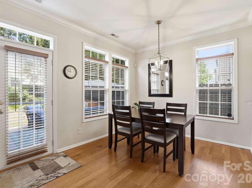 5304 Silabert Avenue, Charlotte, NC 28205.  MLS# CAR4398785, YatesRealty ID 34416. Dining area surrounded by windows, creating a bright and inviting space for everyday meals or entertaining.