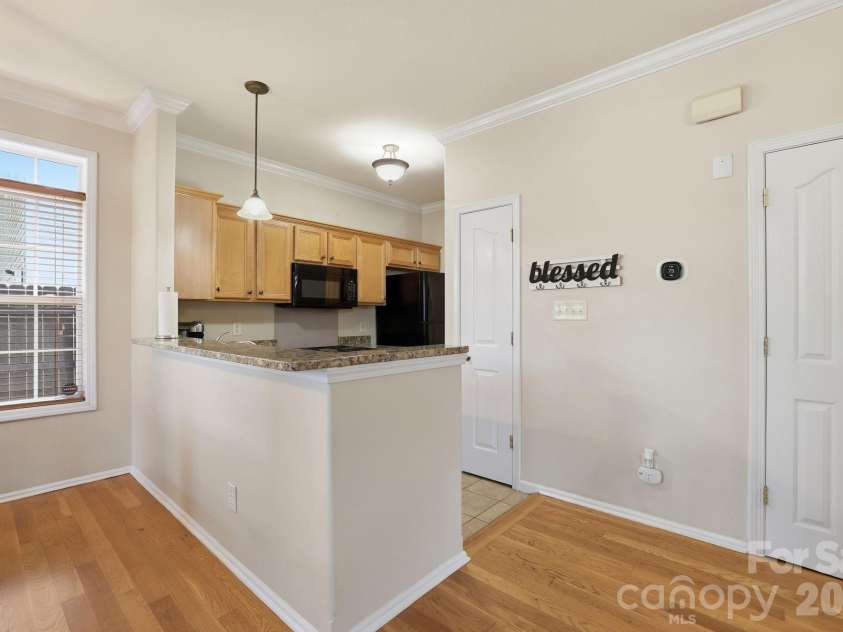5304 Silabert Avenue, Charlotte, NC 28205.  MLS# CAR4398785, YatesRealty ID 34416. Granite countertops and an elevated breakfast bar provide additional seating.
