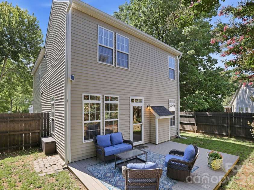 5304 Silabert Avenue, Charlotte, NC 28205.  MLS# CAR4398785, YatesRealty ID 34416. Rear elevation showcasing the expansive deck, fenced yard, and beautiful tree-lined setting.