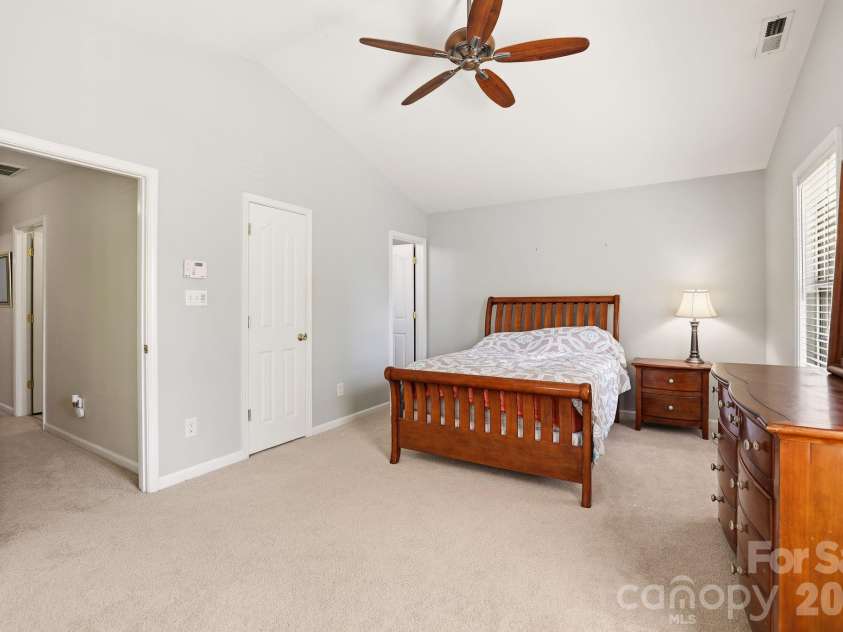 5304 Silabert Avenue, Charlotte, NC 28205.  MLS# CAR4398785, YatesRealty ID 34416. Spacious primary suite featuring a soaring vaulted ceiling, abundant natural light, and direct access to the ensuite bath and walk-in closet.