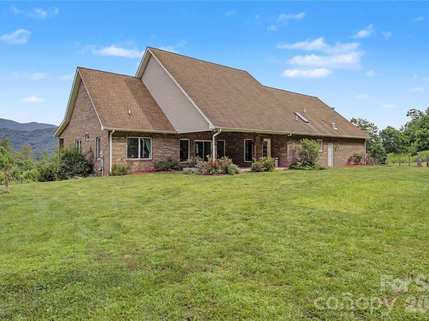 340 Earlys Mountain Road, Leicester, NC 28748.  MLS# CAR4398900, YatesRealty ID 34431. Back patio is covered and has access to the Living Room and the Primary Bedroom.  There is also a propane hookup for a grill.