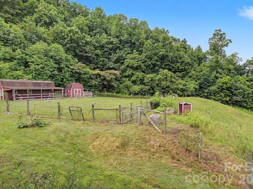 340 Earlys Mountain Road, Leicester, NC 28748.  MLS# CAR4398900, YatesRealty ID 34431. Barn and Shed in level field fully fenced.  Both structures need work.