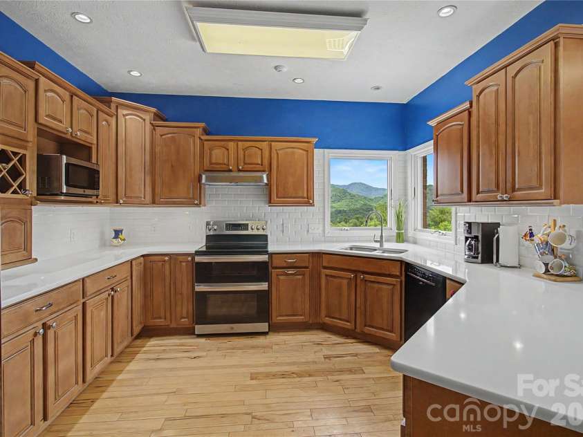 340 Earlys Mountain Road, Leicester, NC 28748.  MLS# CAR4398900, YatesRealty ID 34431. Enjoy cooking in the expansive kitchen featuring generous countertop space and ample cabinetry for all your storage needs.