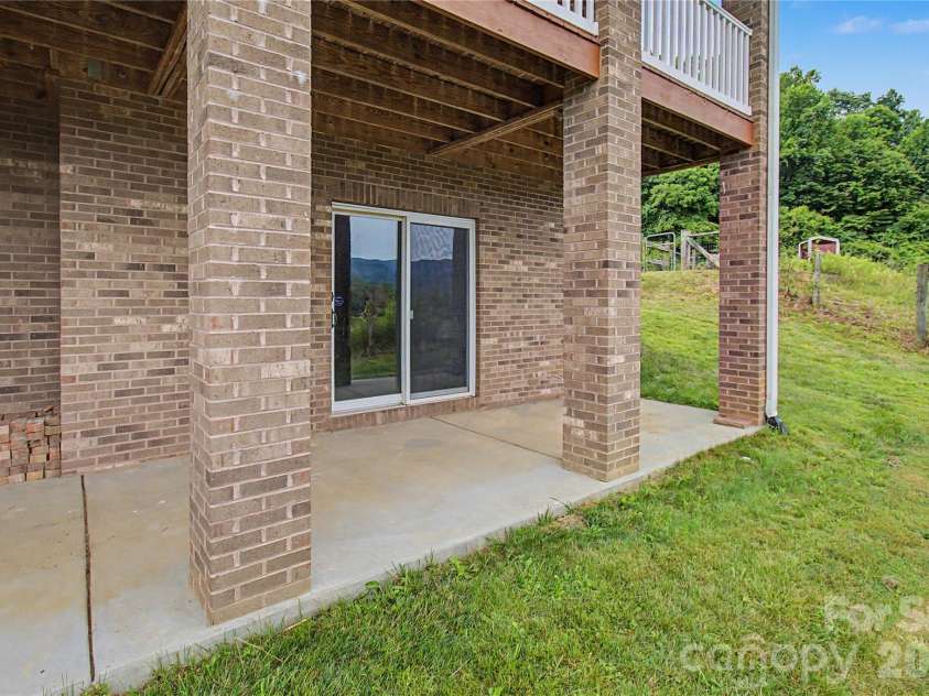 340 Earlys Mountain Road, Leicester, NC 28748.  MLS# CAR4398900, YatesRealty ID 34431. Exterior entrance to unfinished basement