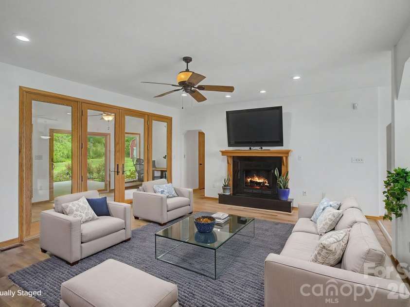 340 Earlys Mountain Road, Leicester, NC 28748.  MLS# CAR4398900, YatesRealty ID 34431. Living room with propane fireplace. Virtually Staged 