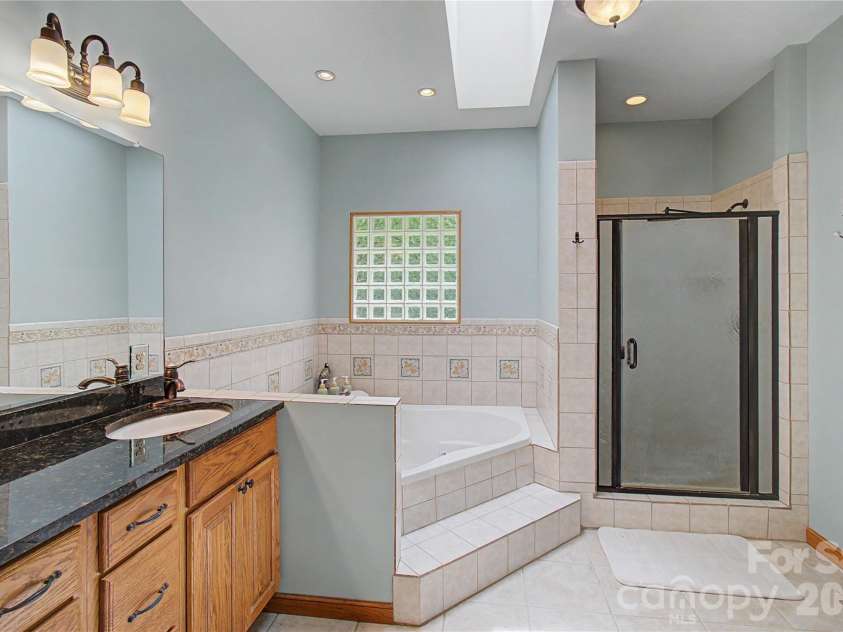 340 Earlys Mountain Road, Leicester, NC 28748.  MLS# CAR4398900, YatesRealty ID 34431. Primary Bathroom has dual vanities, jetted soaking tub & shower