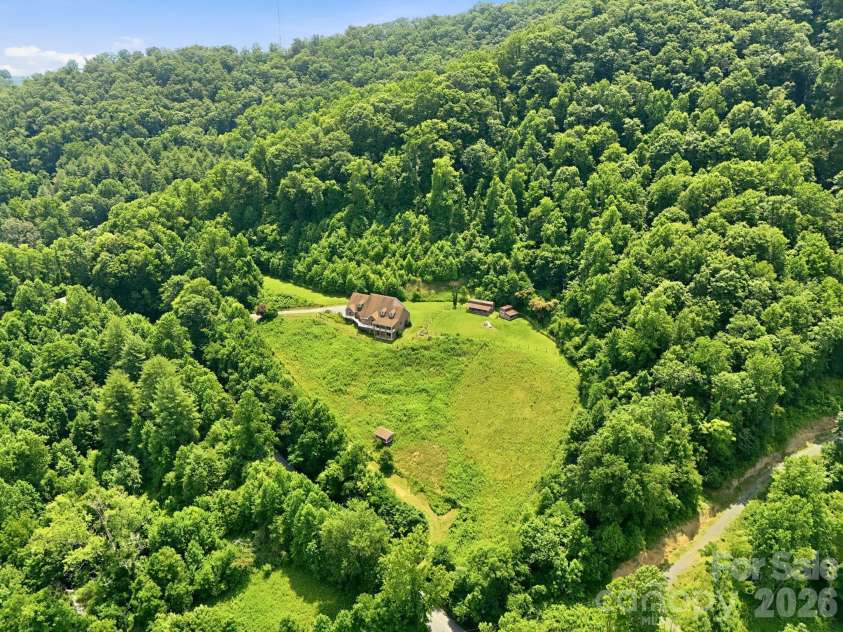 340 Earlys Mountain Road, Leicester, NC 28748.  MLS# CAR4398900, YatesRealty ID 34431. Property has the main paved driveway on the upper end and a dirt road further down.  The dirt road is easy access for the bottom two fields and connects the lower driveway with the paved upper driveway.  