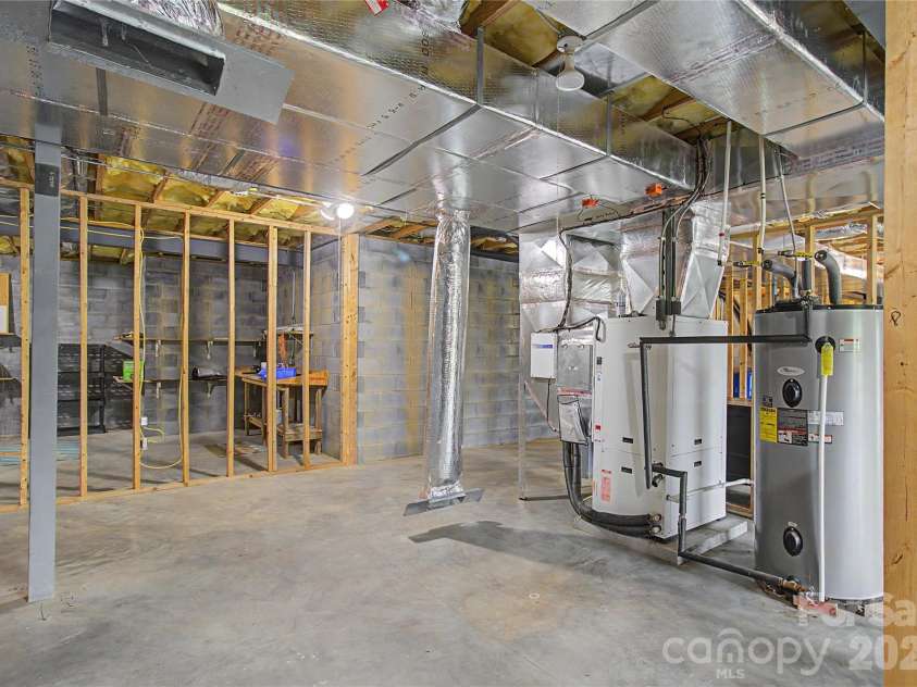 340 Earlys Mountain Road, Leicester, NC 28748.  MLS# CAR4398900, YatesRealty ID 34431. Unfinished Basement. Photo shows ductwork in place, GeoThermal furnace & electric hot water tank.