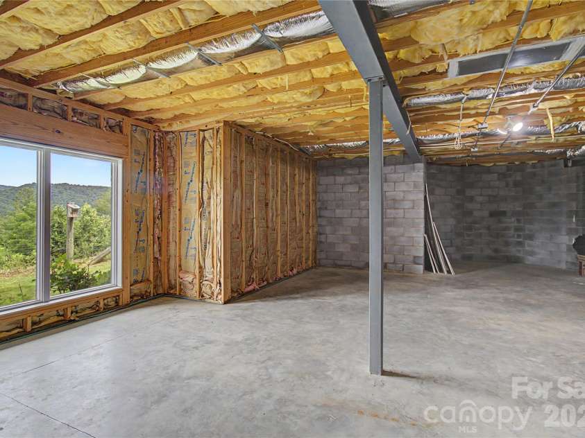 340 Earlys Mountain Road, Leicester, NC 28748.  MLS# CAR4398900, YatesRealty ID 34431. Unfinished Basement with heating/ac already ran.  This massive space is ready for you to make it your own.  Oh and look at the views from this area!