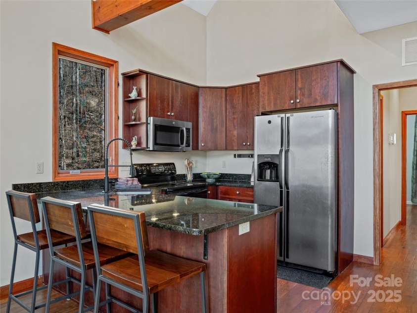 45 Wilderness Drive, Weaverville, NC 28787.  MLS# CAR4221623, YatesRealty ID 3444. Rich wooden cabinets and granite countertops