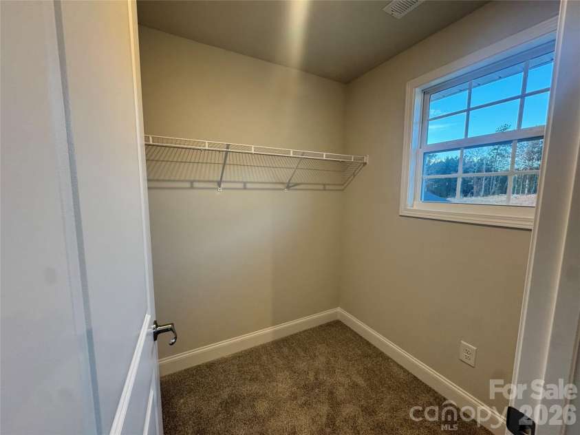 712 Inwood Hill Drive, Gastonia, NC 28056.  MLS# CAR4399206, YatesRealty ID 34440. Bedroom 2 walk-in closet Representative Photo